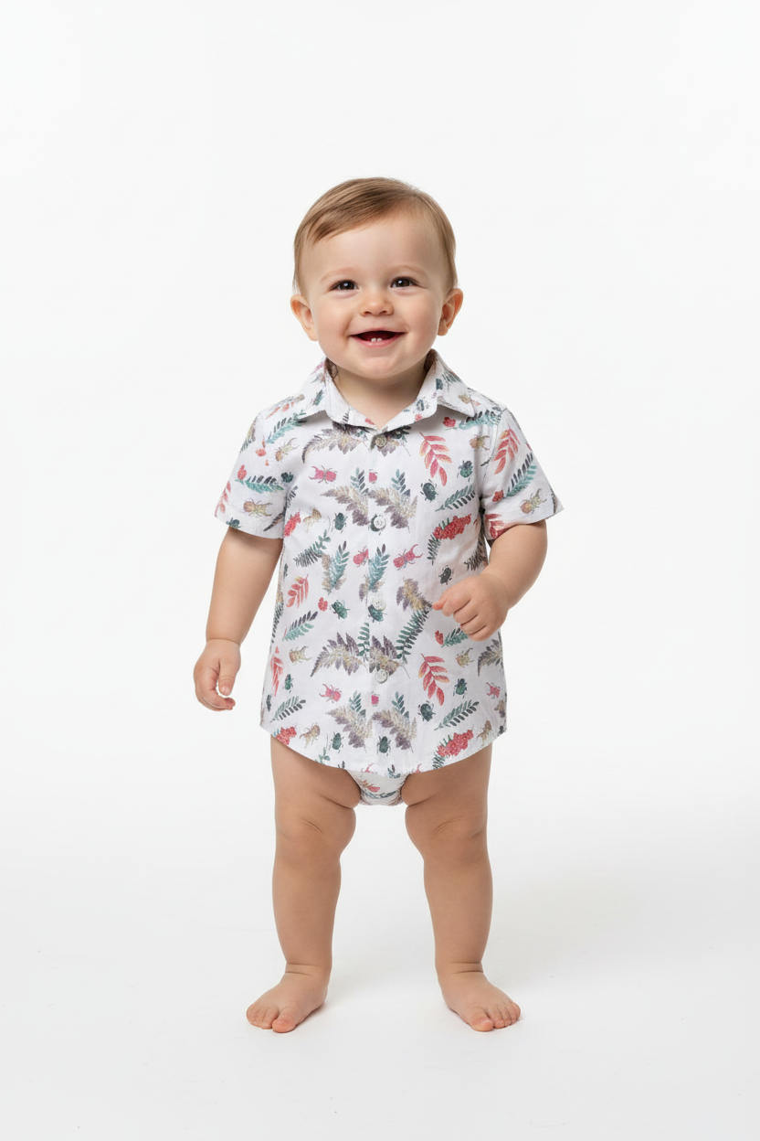 Baby boy standing wearing botanical print shirt
