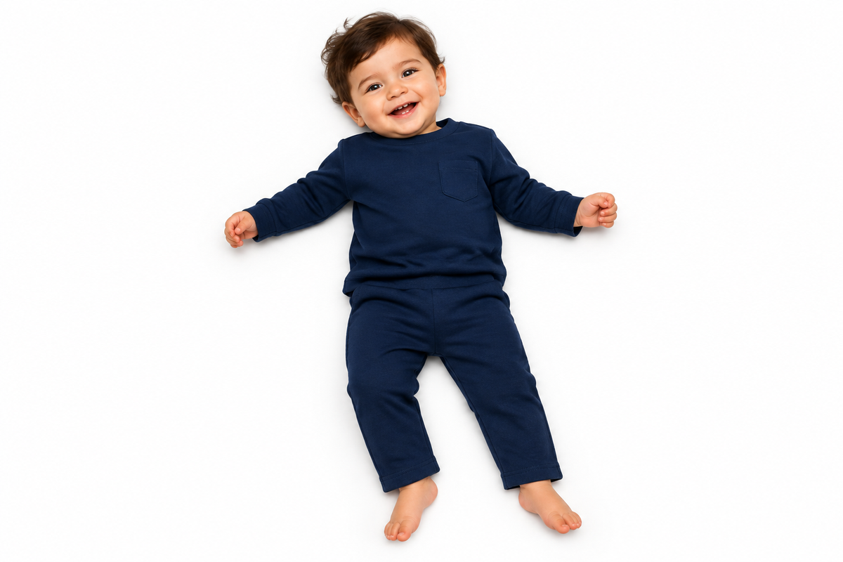 Baby in navy set with straight hem trousers, lying down