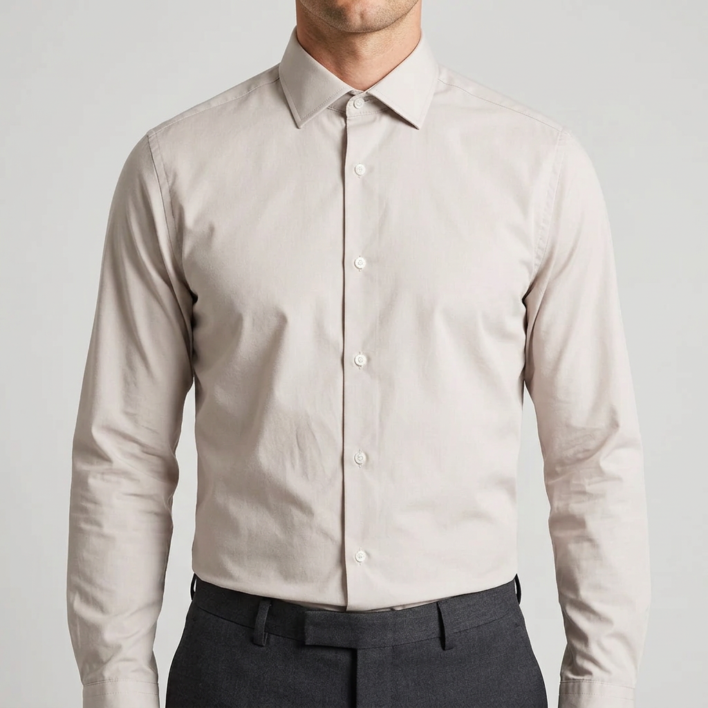 Beige shirt tucked in with every button closed, including the top collar button