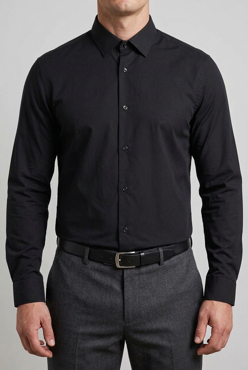 Black shirt fully buttoned at the collar and tucked into trousers