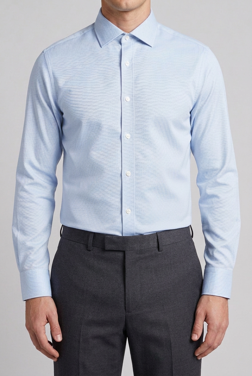 Lighter blue shirt fully tucked into trousers
