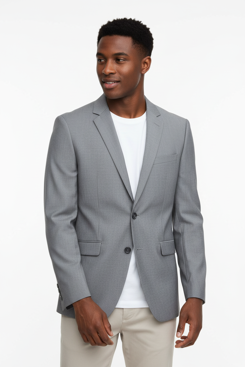 Man of colour wearing light grey blazer, face to hip