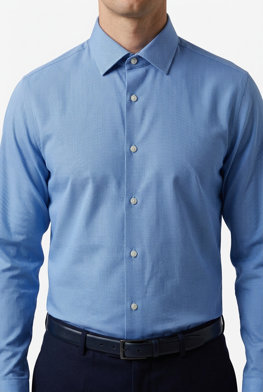 Model wearing the blue shirt tucked in with the collar fully buttoned